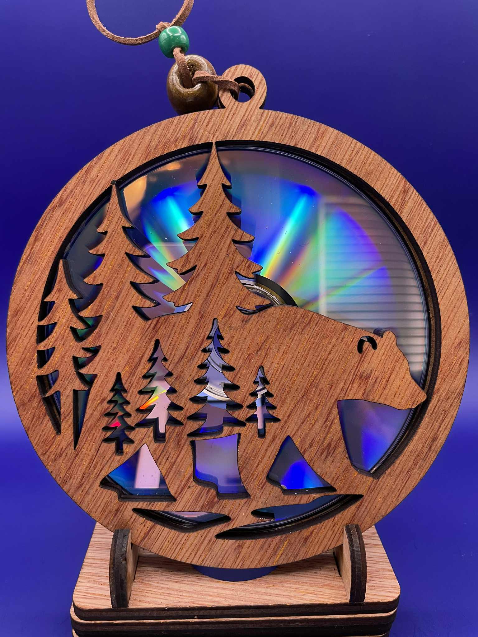 Bear and pine tree suncatcher made from a recycled disc